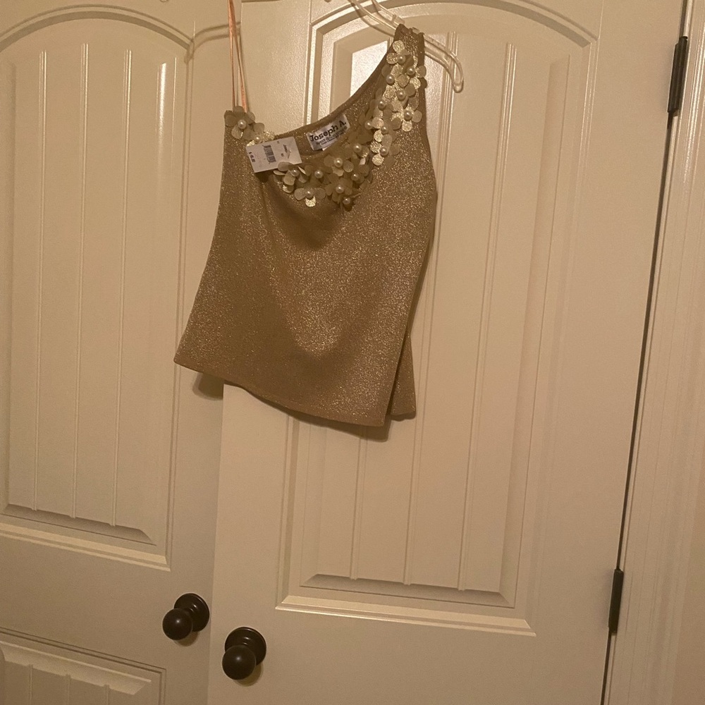 Gold one shoulder top with florettes and pearls.